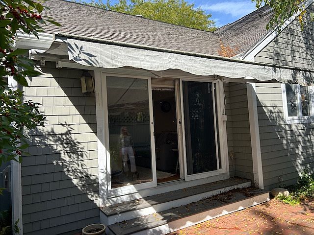 paver patio off family room/ with awning