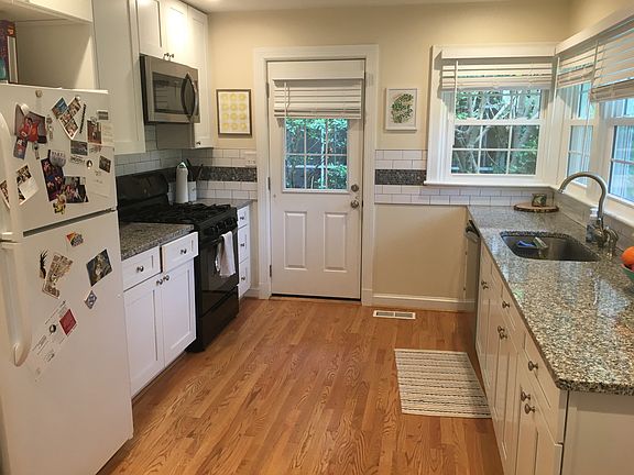 Kitchen with gas stove, microwave, refrigerator, and dishwasher