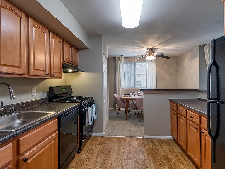 Designer Kitchens With, Wood Flooring, Sleek Black Appliances & Solid Wood Cabinets