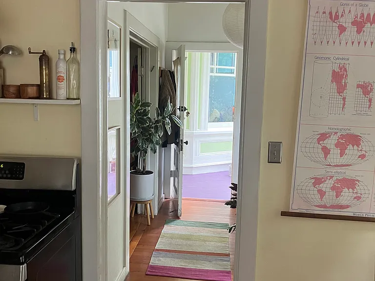 Looking from the kitchen through sunroom to the front door