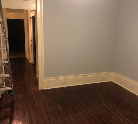 Living room and entry into short hallway