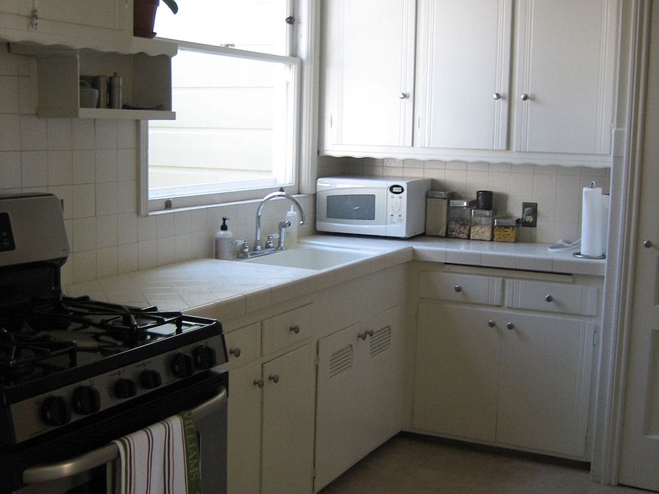 Kitchen with gas stove and refrigerator - often sun splashed 