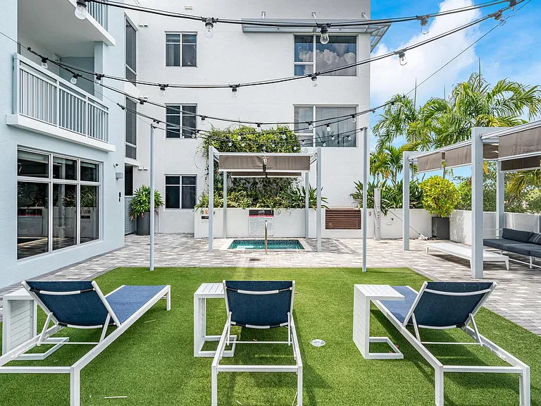 Outdoor Lounge Space With Covered Seating and Lawn Chairs