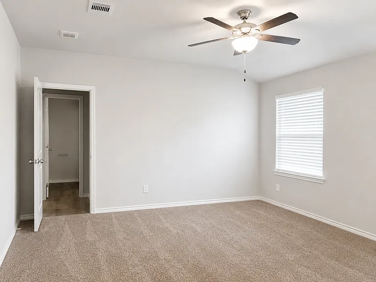 Primary bedroom with ceiling fan
