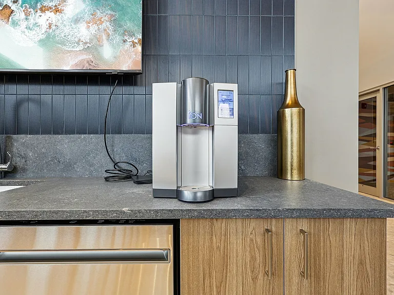 Experience modern convenience with a touch of elegance in this stylish kitchen setup.