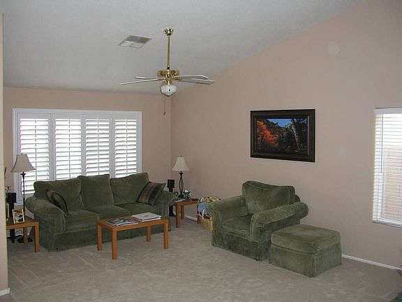 Inviting formal room with plantation shutters.