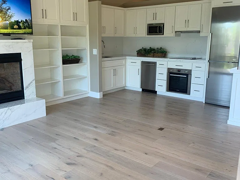 View of kitchen and living room area. Open concept studio.