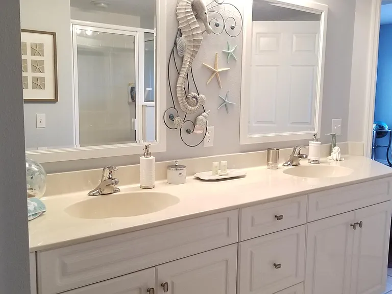 The main bedroom boasts a beautiful large bathroom with walking closet and his and her sinks