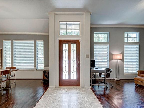 Light and welcoming entry way with formal dining room to the left and formal living area to the right that would also make a great study or library.