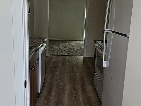 View of laundry room then kitchen from back door