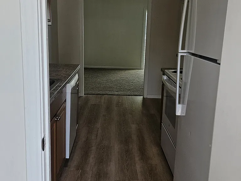View of laundry room then kitchen from back door