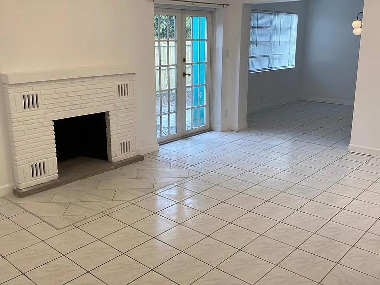 Living room with private adjoining fenced patio area