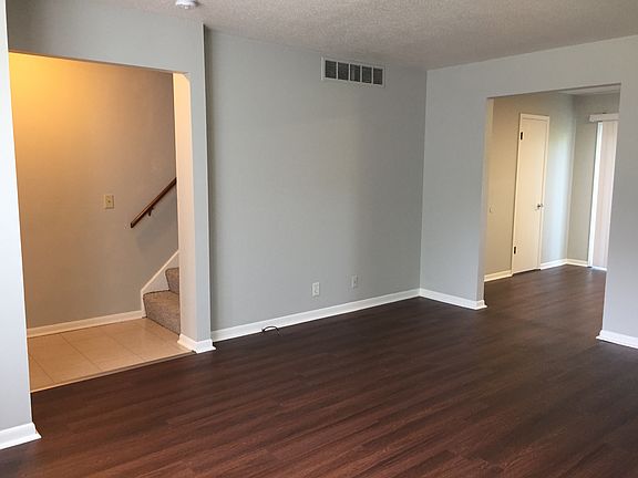 In the living room. Entry and stairs to the left. View of kitchen entry.