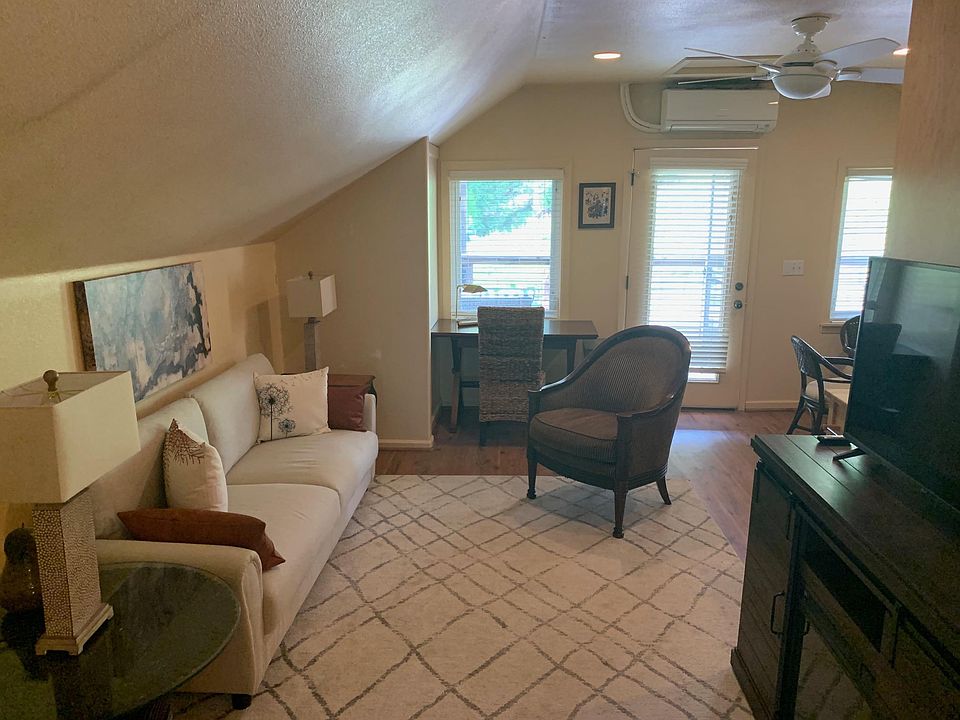 Entry door ..... Desk/office area - note living room area with electronic fireplace/book shelve/cabinet storage.