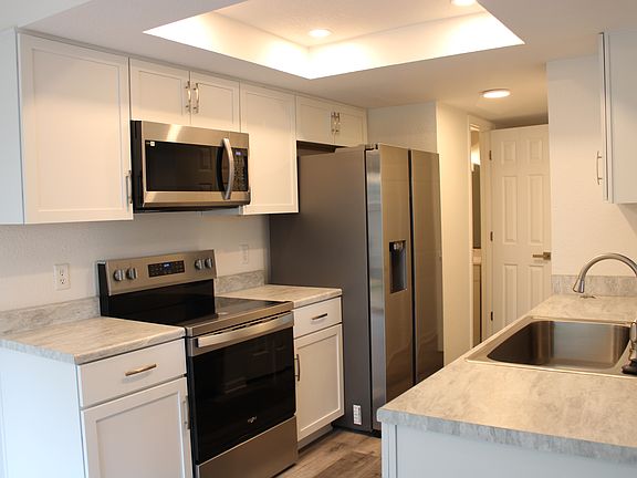 Fully renovated galley style kitchen with new full sized appliances, new countertops and brand new cabinets. Refrigerator features in-door ice maker