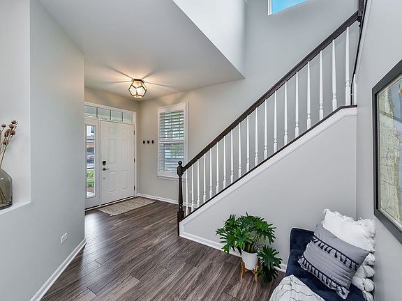 Upgraded staircase, coat closet next to front door (not pictured), and welcoming nook.