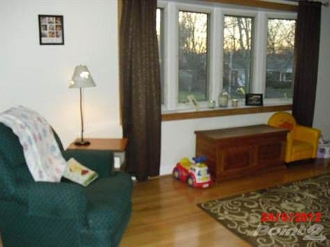 Nice picture window in the living room with hardwood floors