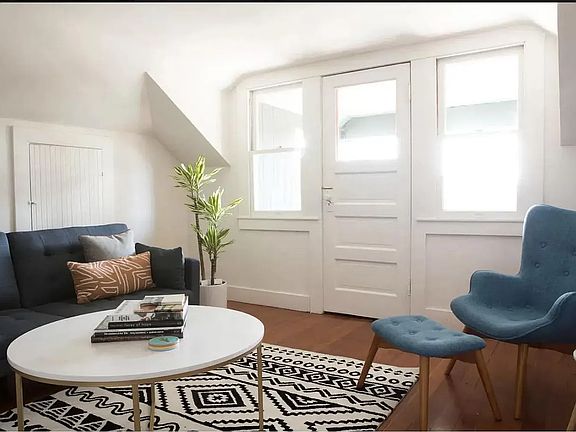 The living room leads to a private balcony that offers a scenic view of downtown L.A. skyline.