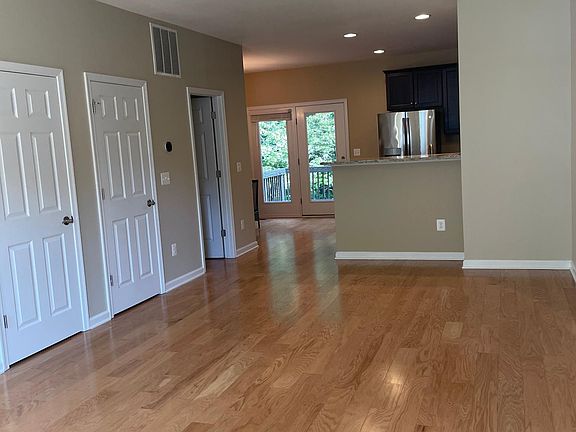 Living room, kitchen, glass doors to deck. Lots of light!