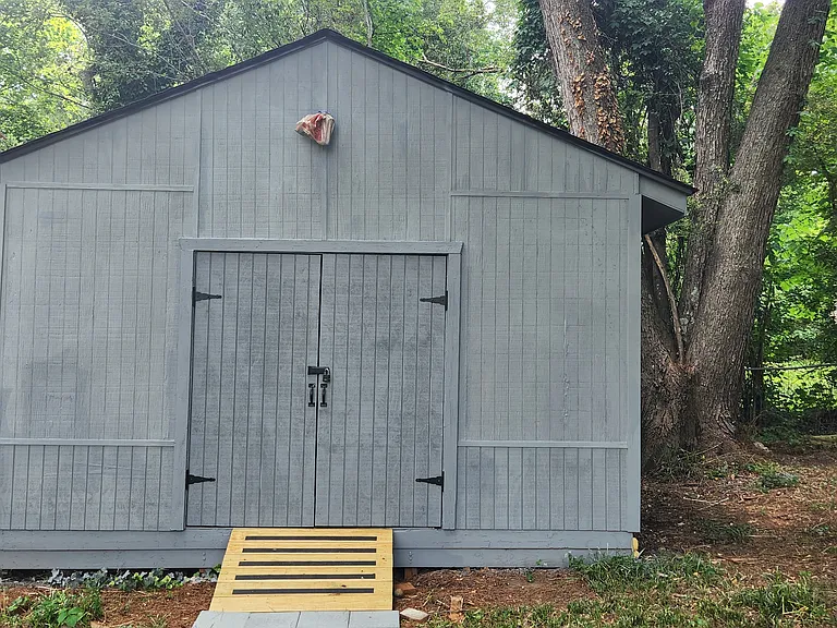 Large shed (16' x 16') in backyard for storage or a workshop.