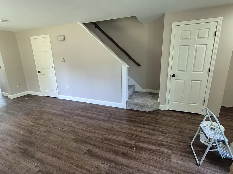 living room and washer and dryer behind left door