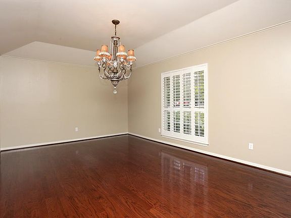 The large DINING ROOM (18'x13') has tray ceilings, a chandelier and crown molding.