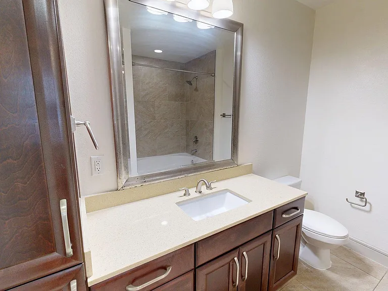 Apartment Bathroom with large soaking tub and Tile Flooring.