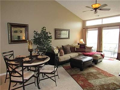 Great Room. The large great room features cathedral ceiling, gorgeous ceiling fan, and nice transom window above sliding doors that lead out onto your deck.