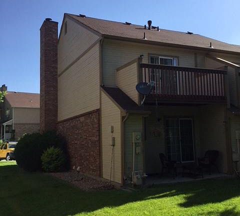 South Elevation with master bedroom deck and back patio.