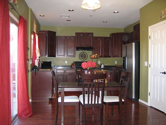 Kitchen w/walnut flooring & staggered cherry stain cabinets