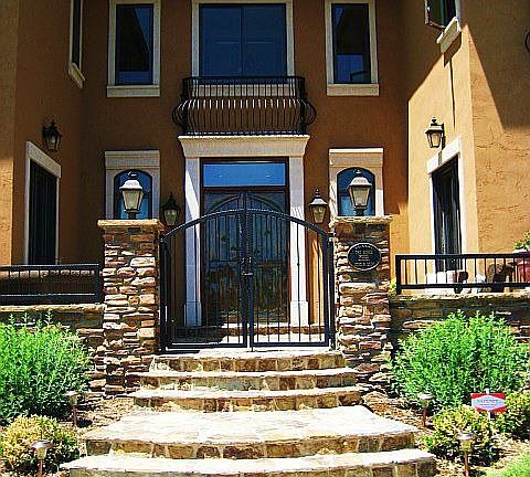 Large stone porch entry with gate