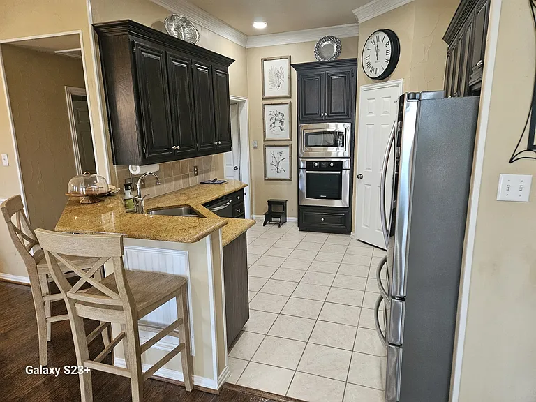 Kitchen with included bar chairs.