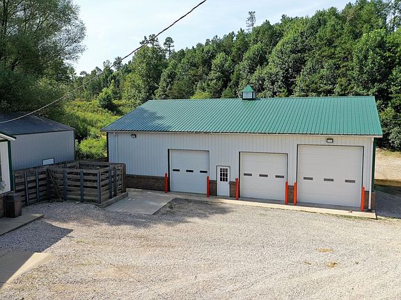 Three bay garage and livestock holding facility (in the back)