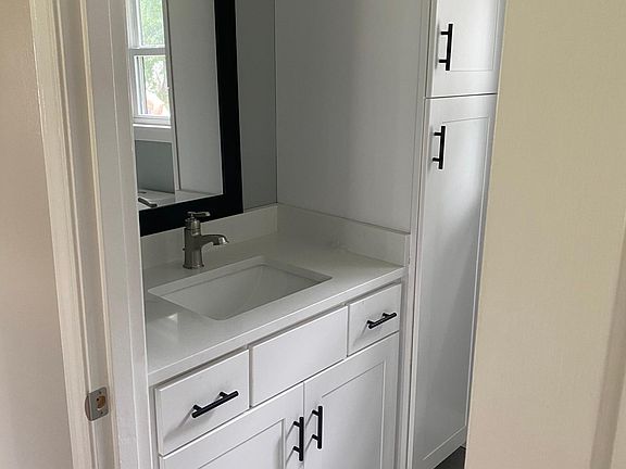 Vanity in bathroom with new cabnets and counter tops and new Facuets