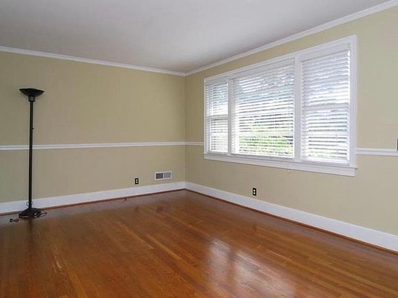 Large living room with large windows to let in the sunlight.