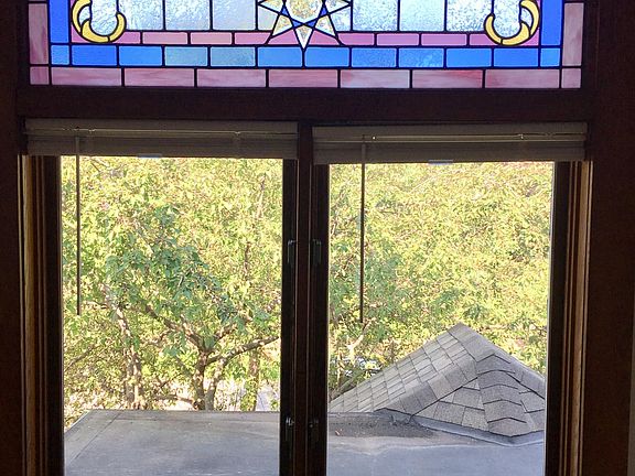 Living room window overlooking the crabapple tree, open to the roof.