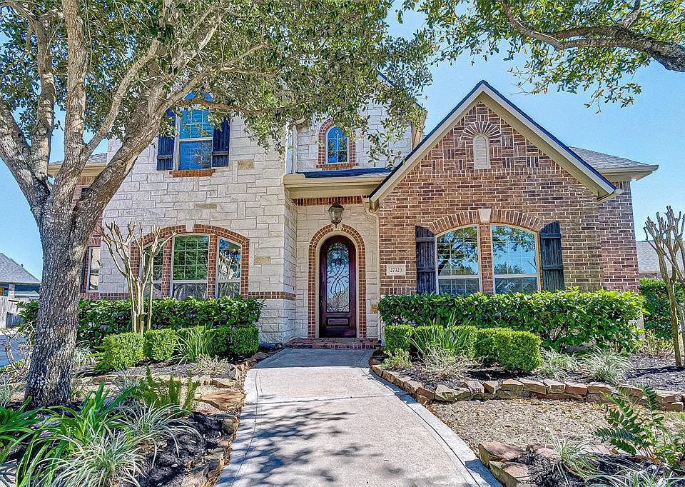 Love the arched front door & plantation shutters across the front of the home