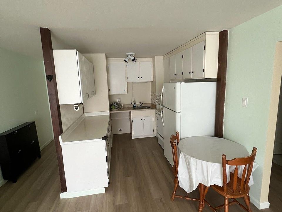 Kitchen with new laminate wood floors. Refrigerator included.