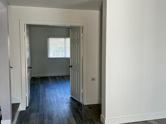 View from front door to double door office/bedroom 1/den. New flooring and paint throughout