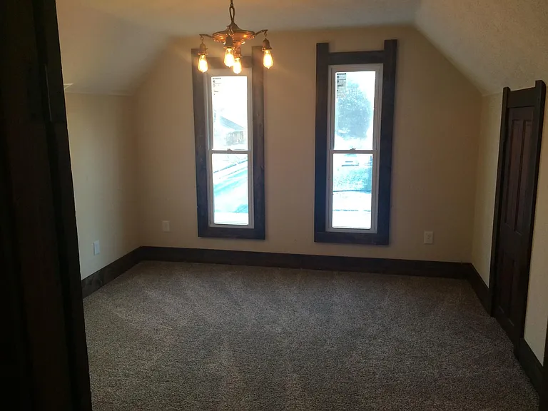 Upstairs Bedroom, the largest of the three upstairs. period lighting, new thermal pain windows. The largest bedroom has a 4 bulb fixture, the smallest a 2 bulb fixture