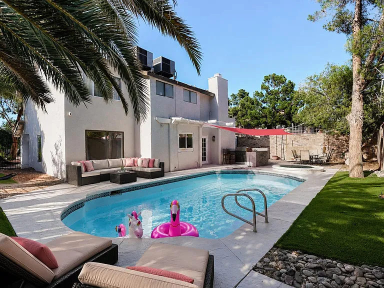 Private backyard retreat with in-ground pool, lounge seating, and shaded patio diningideal for relaxing or hosting.