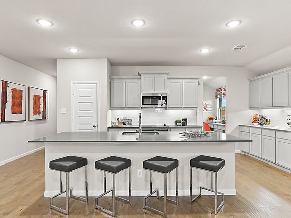 Kitchen in the Heisman home plan by Trophy Signature Homes - REPRESENTATIVE PHOTO