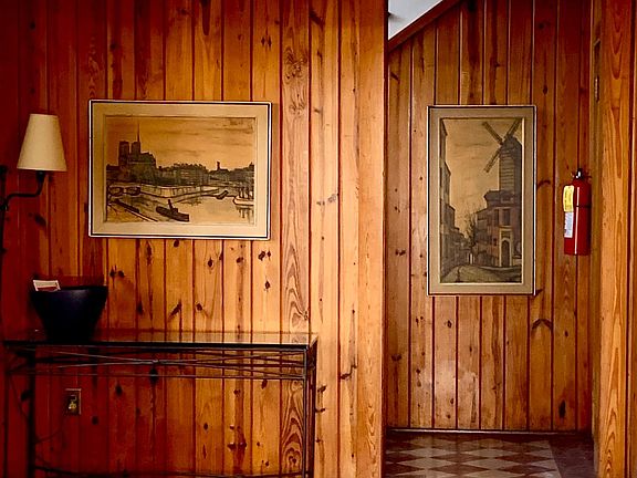 Original pine paneling in the home's foyer entrance into apartment