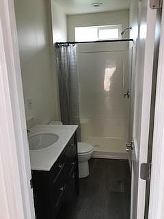 Bathroom with heater and fan plus window for natural light and air.