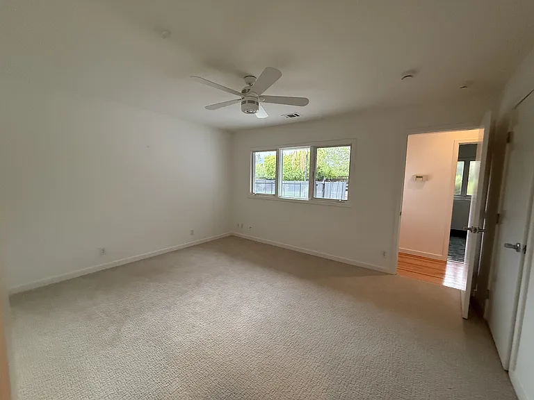 First bedroom has ceiling fan, spacious closet and comfortable plush carpet.
