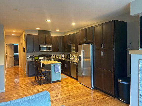 Kitchen with Bosch appliances, movable butcher-block top island with breakfast bar and storage.
