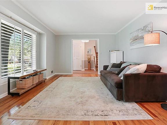 Beautiful living room with hardwood floors, plantation shutters, and amazing light