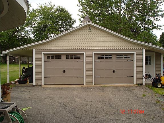 This garage is a guys dream! All new siding, wiring, roof, doors and tool room