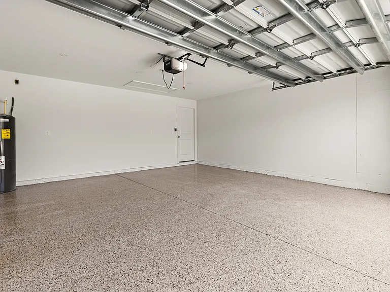 Custom epoxy garage floor with recessed light.