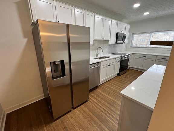 Kicthen view 2, Side-by-side fridge, dishwasher, quartz counters, plentiful cabinets